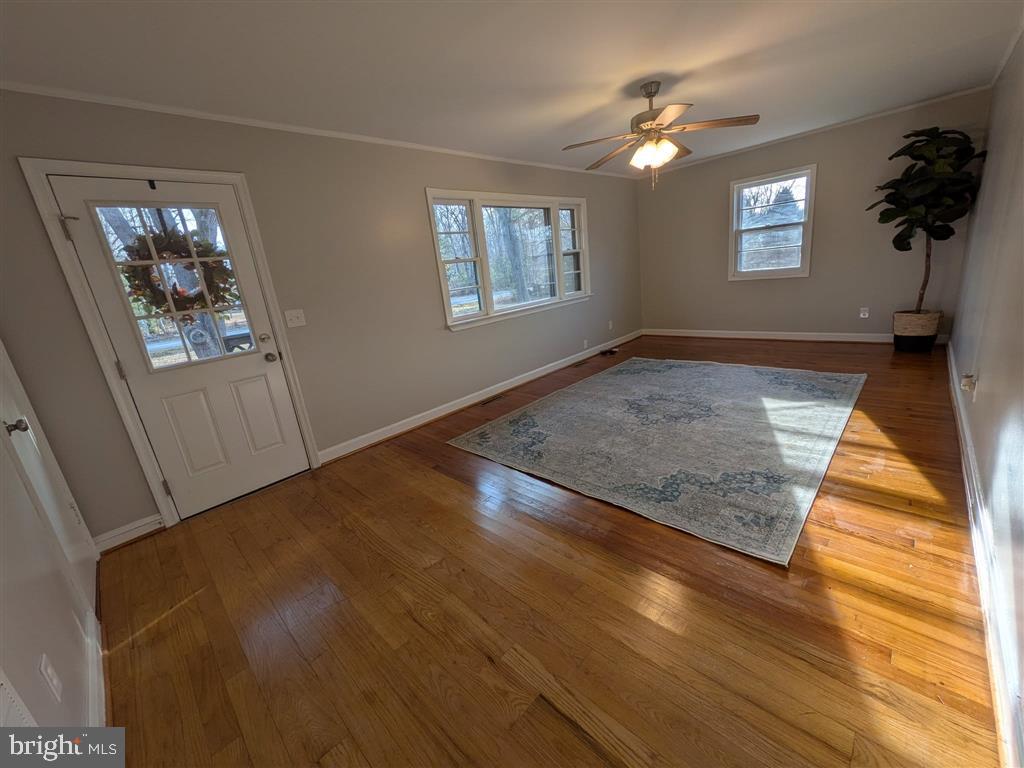 12477 Cox Mill Road Gordonsville, VA 22942 - Photo 3 of 6 wooden floor in an empty room with a window
