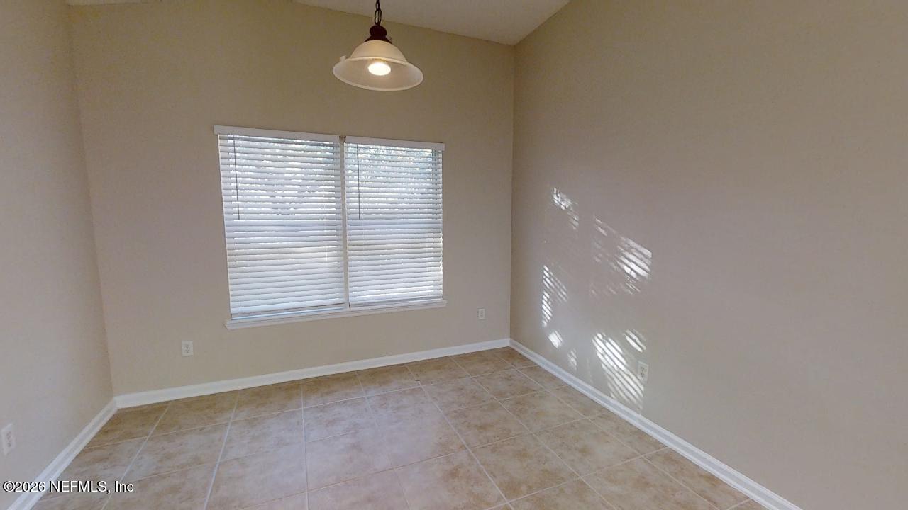 14454 Millhopper Road Jacksonville, FL 32258 - Photo 30 of 44 a view of an empty room with a window