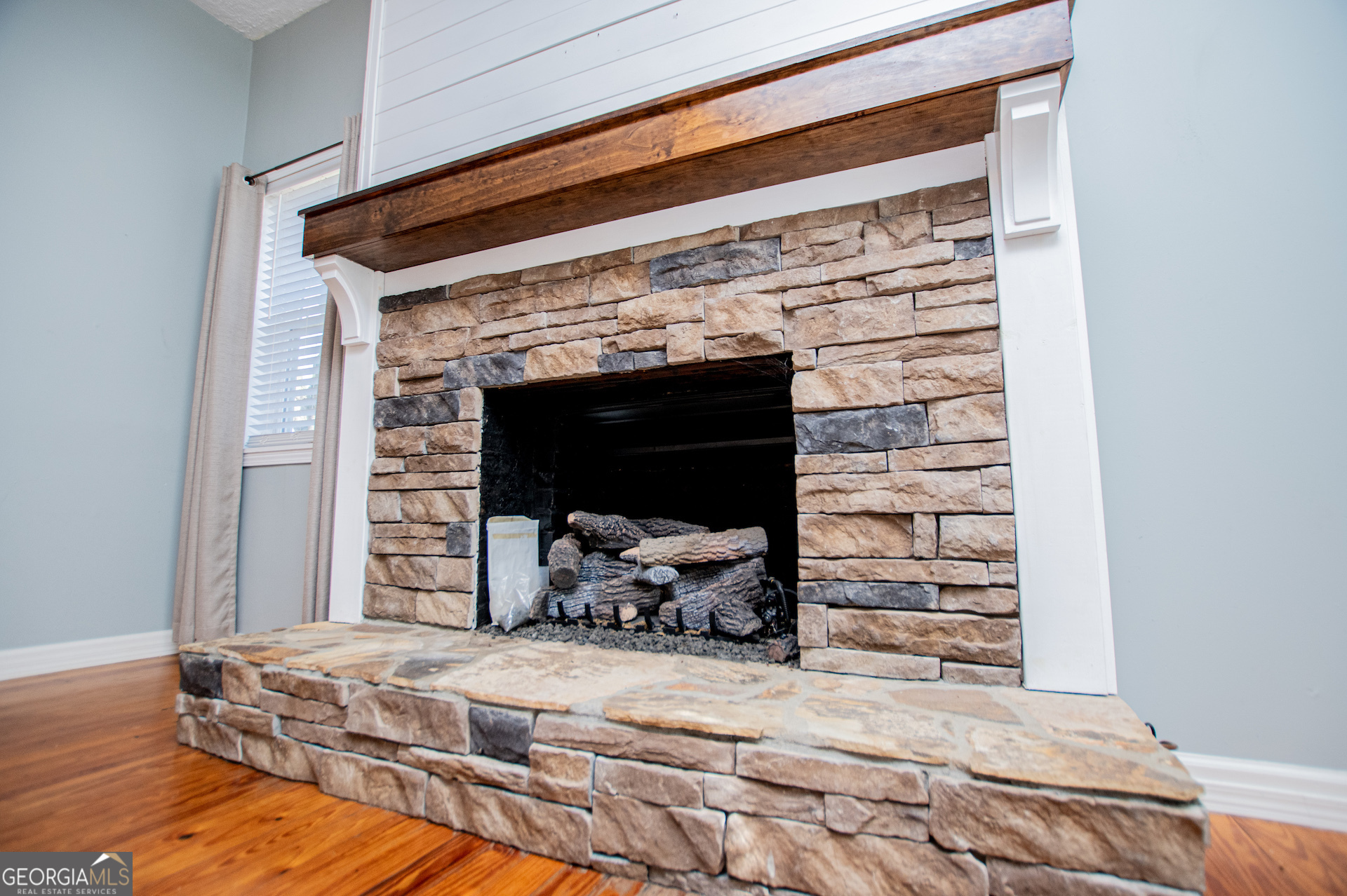 1405 Burwell Road Carrollton, GA 30117 - Photo 11 of 102 a bedroom with a bed and a fireplace