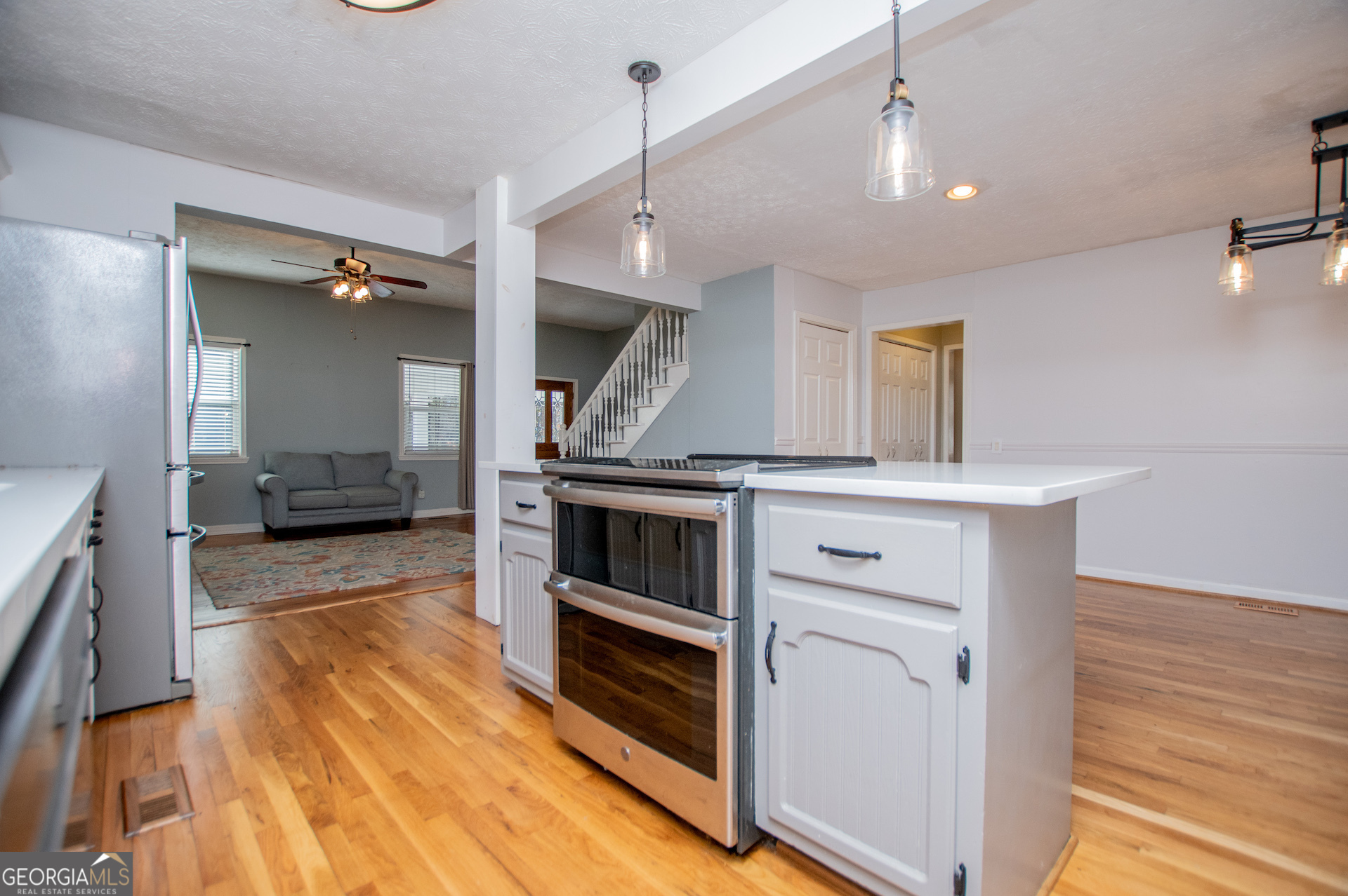 1405 Burwell Road Carrollton, GA 30117 - Photo 15 of 102 a kitchen with a stove and a wooden floor