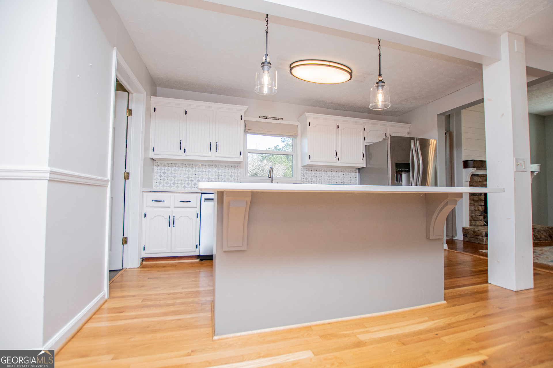 1405 Burwell Road Carrollton, GA 30117 - Photo 18 of 102 a kitchen with stainless steel appliances granite countertop a refrigerator a sink dishwasher and white countertops with wooden floor