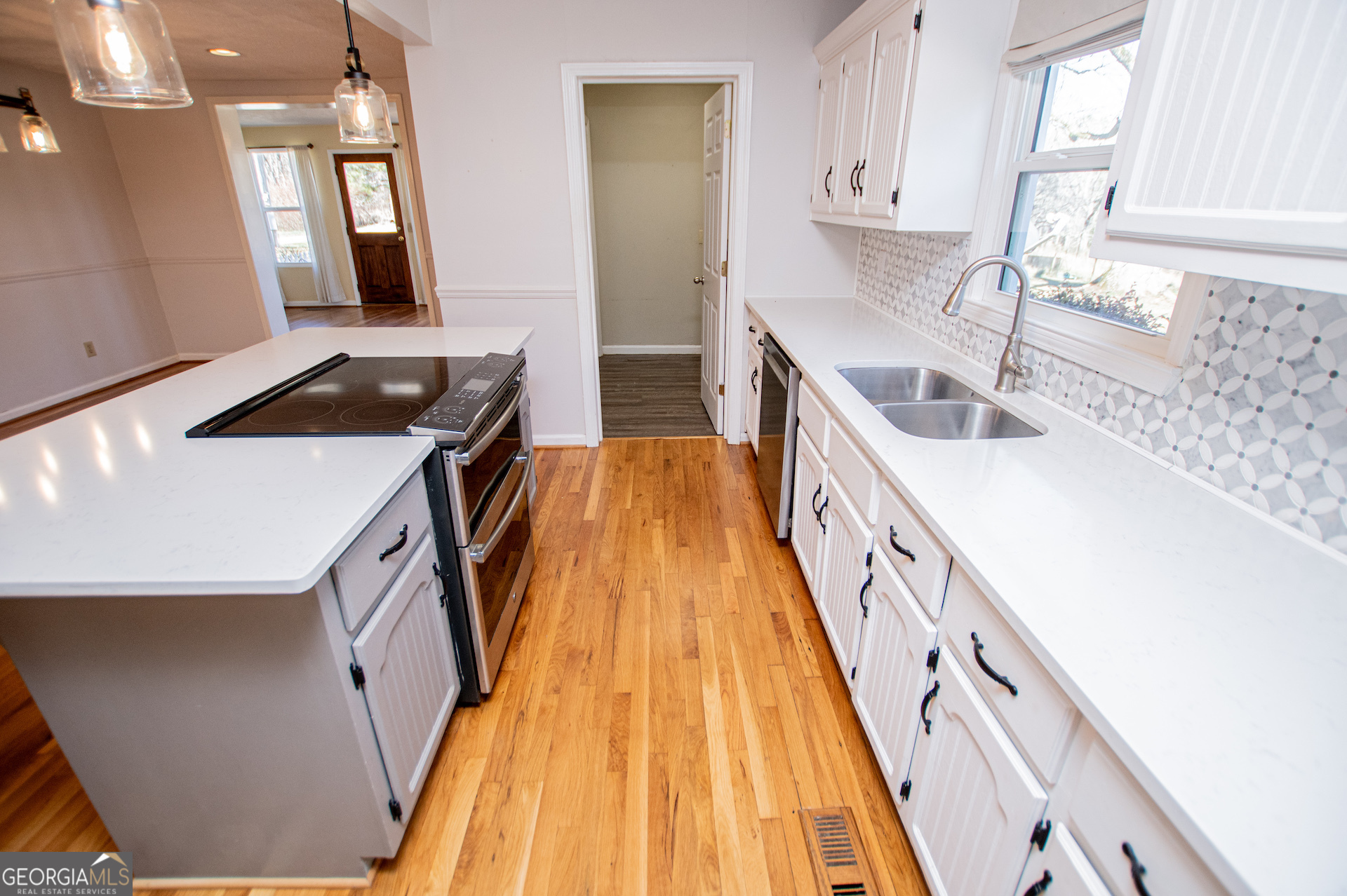 1405 Burwell Road Carrollton, GA 30117 - Photo 24 of 102 a kitchen with a sink a stove and wooden floor