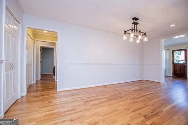 a view of a livingroom with wooden floor and a ceiling fan