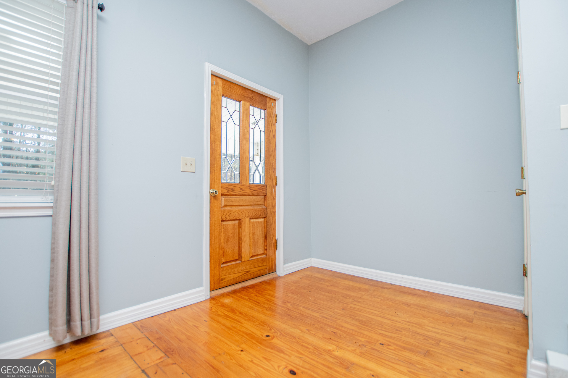 1405 Burwell Road Carrollton, GA 30117 - Photo 4 of 102 a view of empty room with wooden floor and fan