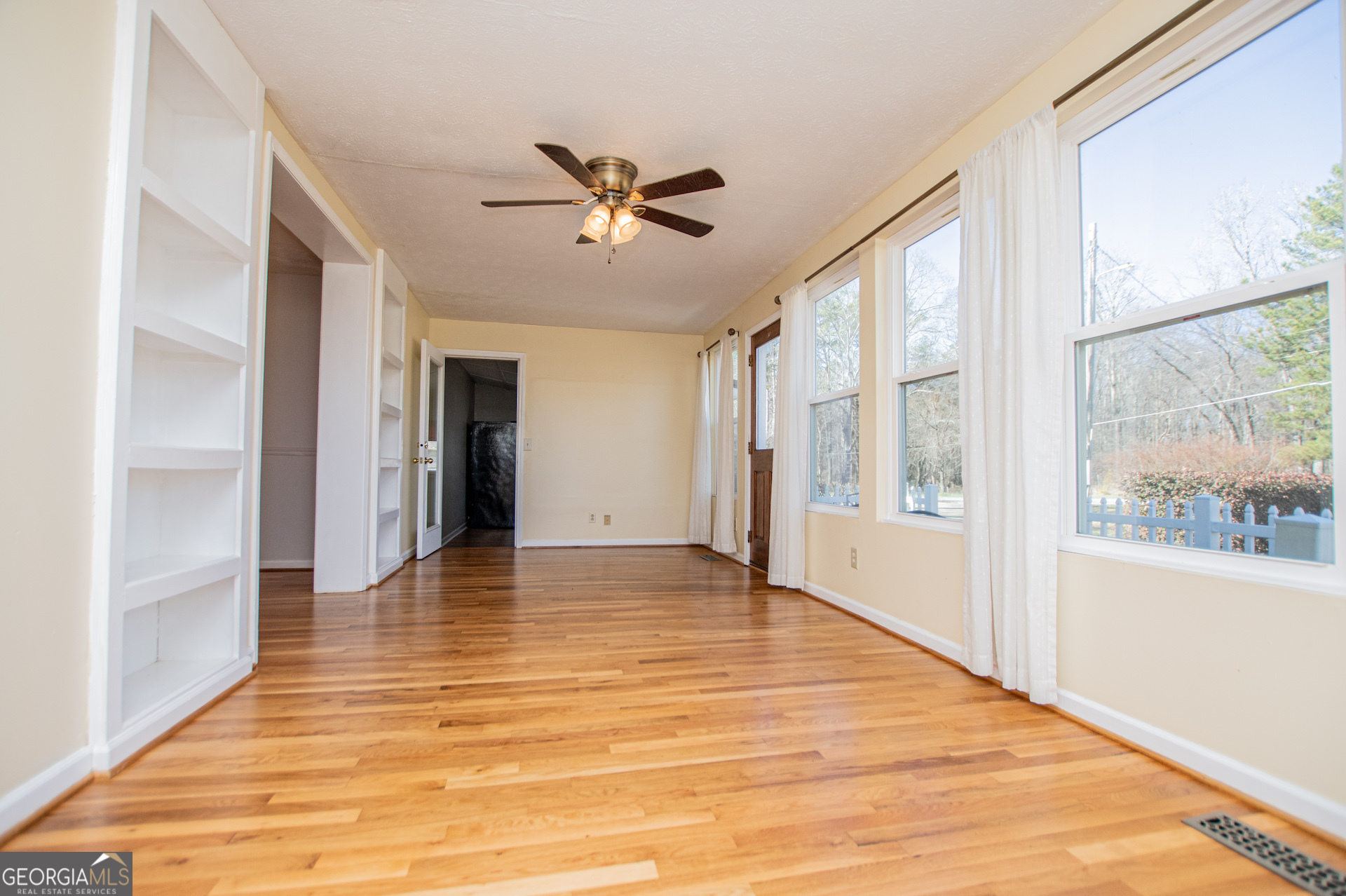 1405 Burwell Road Carrollton, GA 30117 - Photo 42 of 102 a view of an empty room with wooden floor and a window
