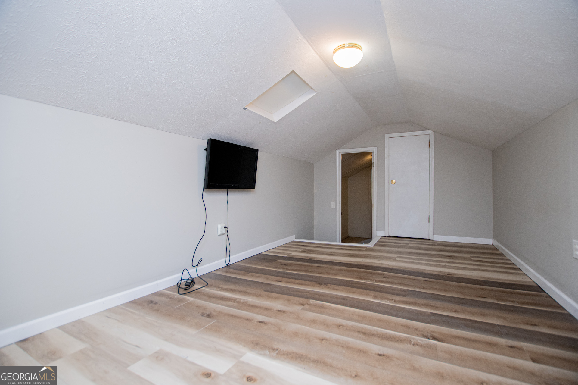 1405 Burwell Road Carrollton, GA 30117 - Photo 52 of 102 a view of a livingroom with wooden floor and a ceiling fan
