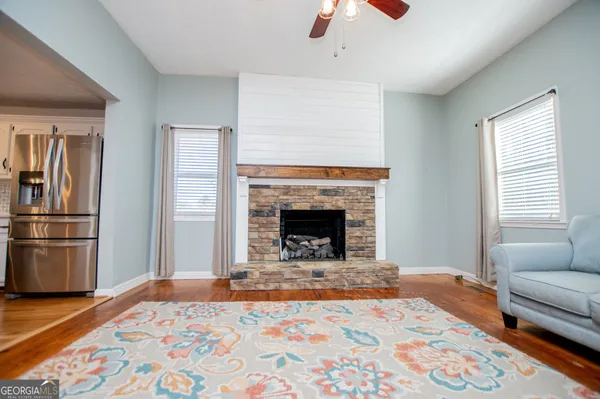 a kitchen with a stove and a wooden floor