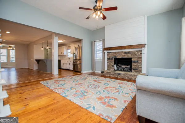 a kitchen with stainless steel appliances granite countertop a stove a refrigerator and a microwave