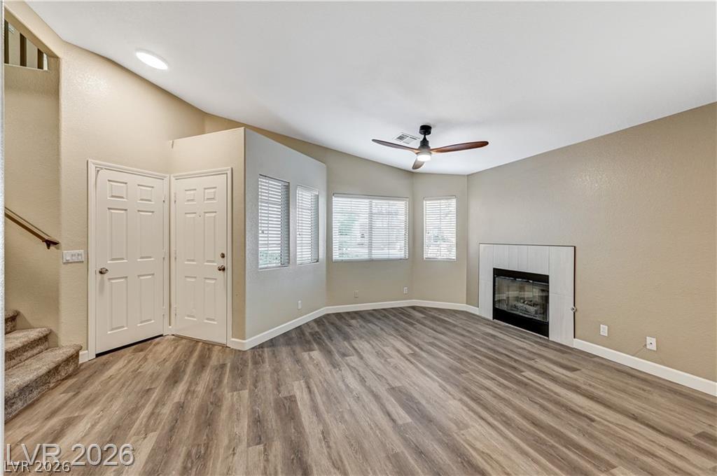 A modern corner fireplace and wood-look flooring anchor this versatile ground floor living space.