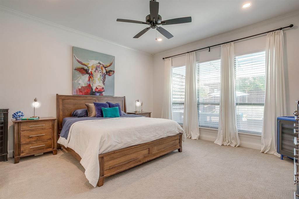 413 Kestrel Court Aledo, TX 76008 - Photo 21 of 40 a spacious bedroom with a bed and a chandelier