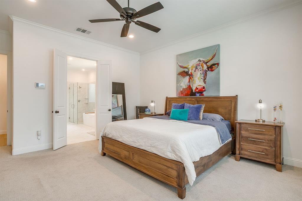 413 Kestrel Court Aledo, TX 76008 - Photo 22 of 40 a bedroom with a bed and a chandelier