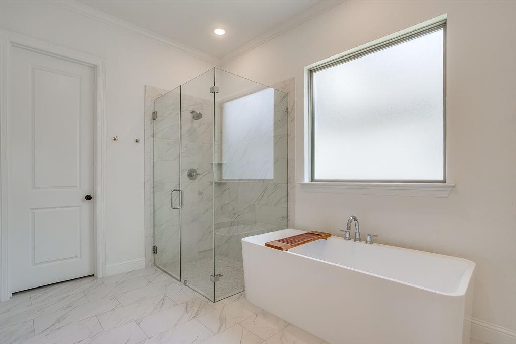413 Kestrel Court Aledo, TX 76008 - Photo 26 of 40 a bathroom with a bathtub and a shower