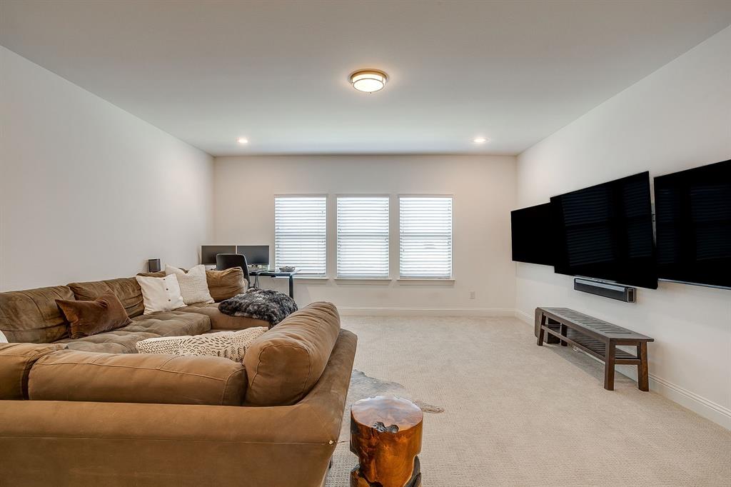 413 Kestrel Court Aledo, TX 76008 - Photo 28 of 40 a living room with furniture and a flat screen tv