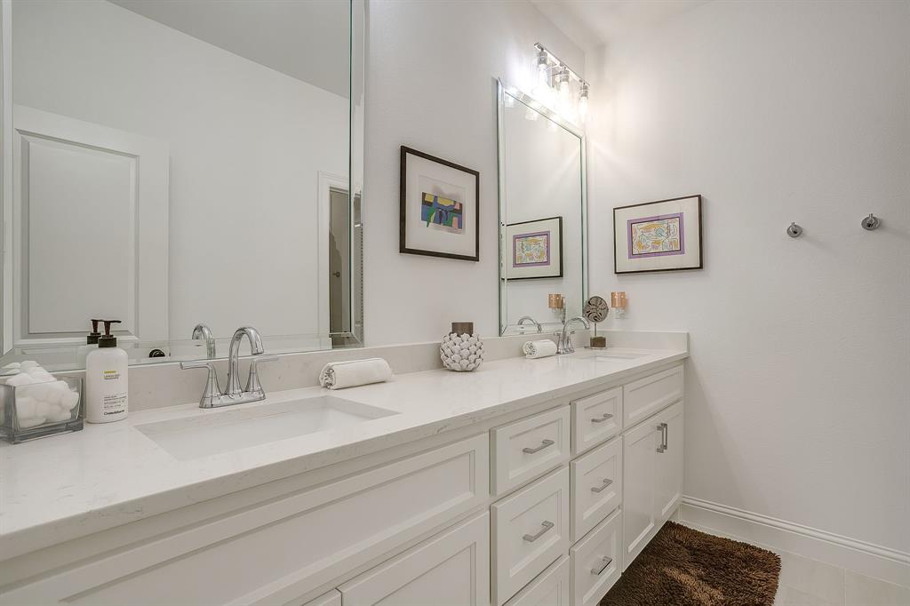 413 Kestrel Court Aledo, TX 76008 - Photo 29 of 40 a bathroom with double sink and a mirror