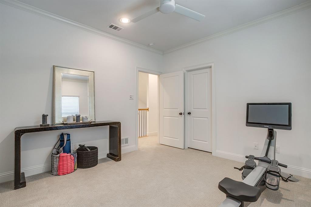 413 Kestrel Court Aledo, TX 76008 - Photo 31 of 40 a room with gym equipment and a mirror