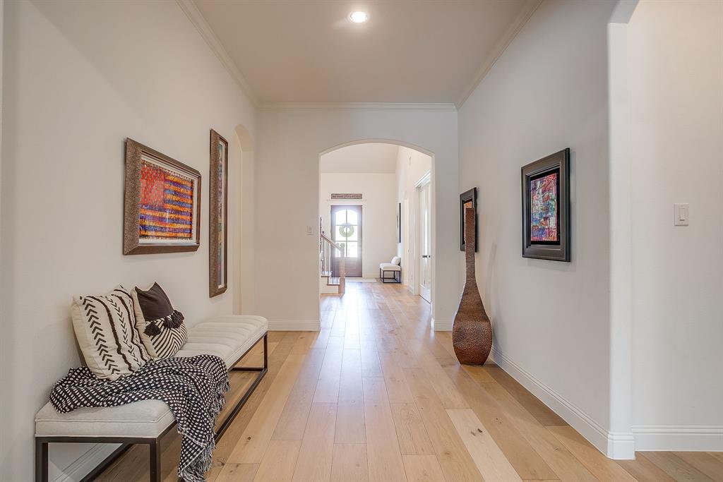 413 Kestrel Court Aledo, TX 76008 - Photo 8 of 40 a hallway with furniture and wooden floor