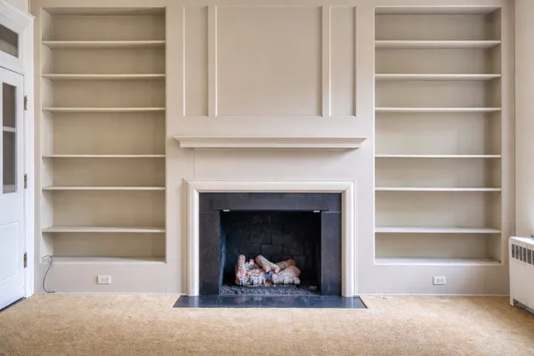 a living room with a fireplace and a fireplace
