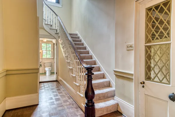 a view of entryway and hall with wooden floor