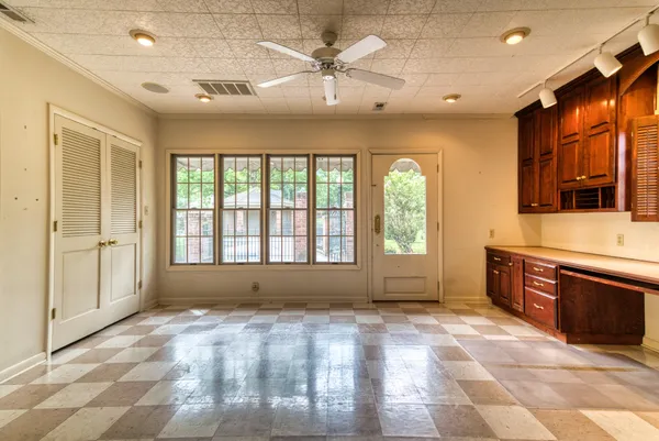 a view of an empty room with a fireplace and a window