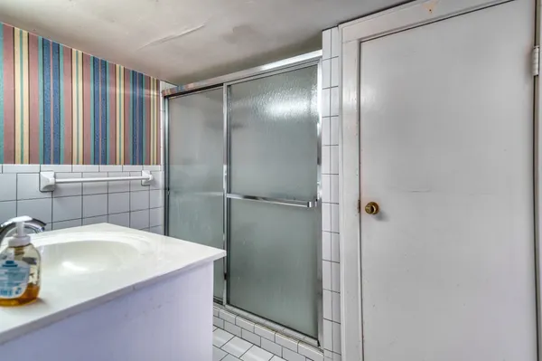 a bathroom with a granite countertop sink mirror and double