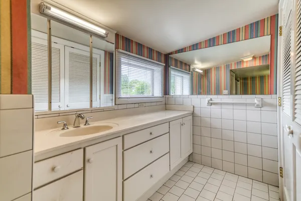 a bathroom with a sink and a mirror