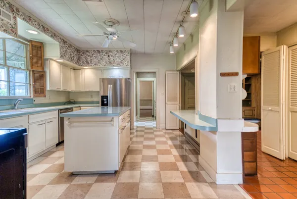 a kitchen with a refrigerator and a sink