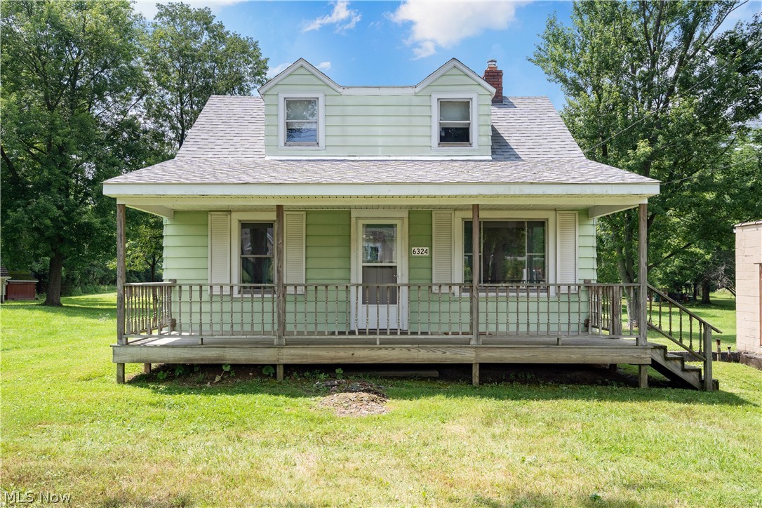 6324 Struthers Road Youngstown, OH 44514 - Photo 1 of 42 Mint green siding residence featuring a covered front porch with wood railings and steps