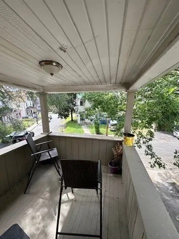 a view of a park with bench and a large tree