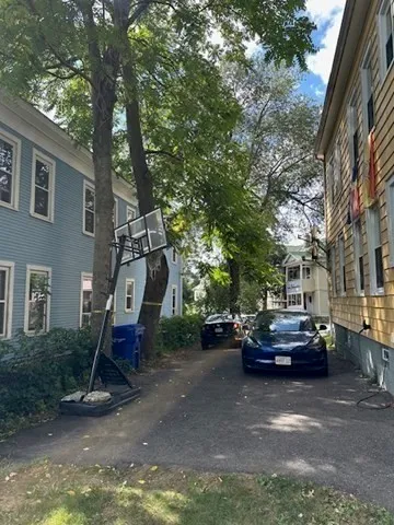 a backyard of a house with table and chairs