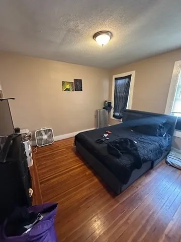 a bed sitting in a room next to a window