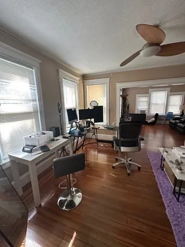 a room with lots of furniture and a wooden floor