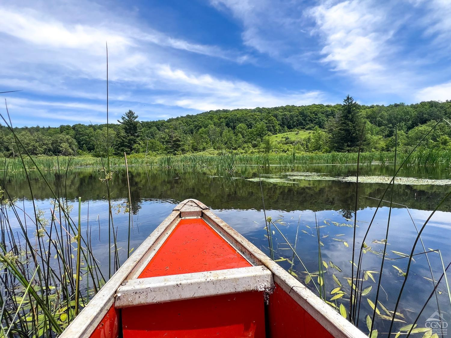 0 Woodland Hills Road Andes, NY 13731 - Photo 27 of 71 a view of a lake with a floor to ceiling window and wooden fence