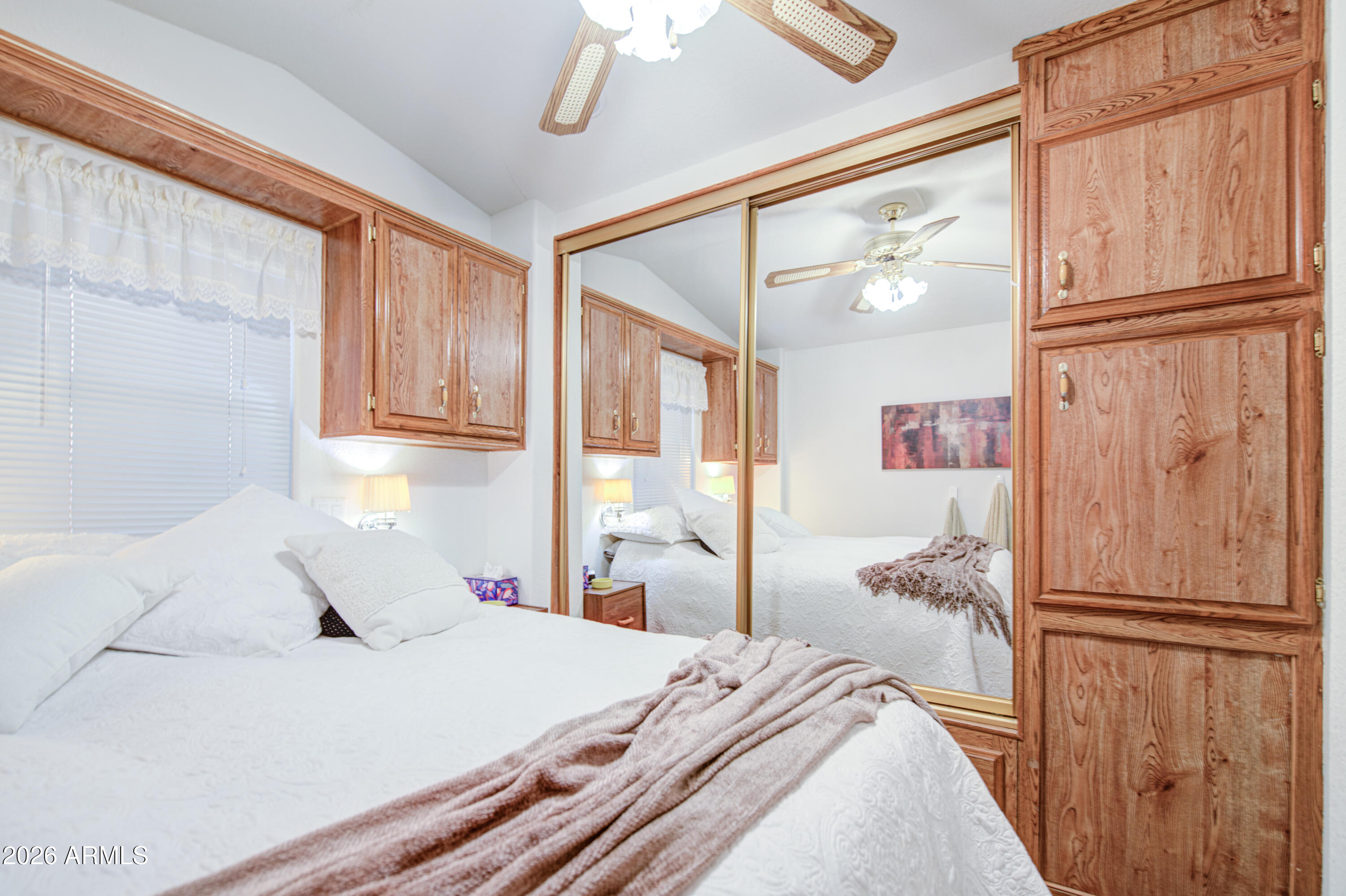 7750 East Broadway Road, Unit 349 Mesa, AZ 85208 - Photo 15 of 39 a bedroom with a large bed and a window with the outer view