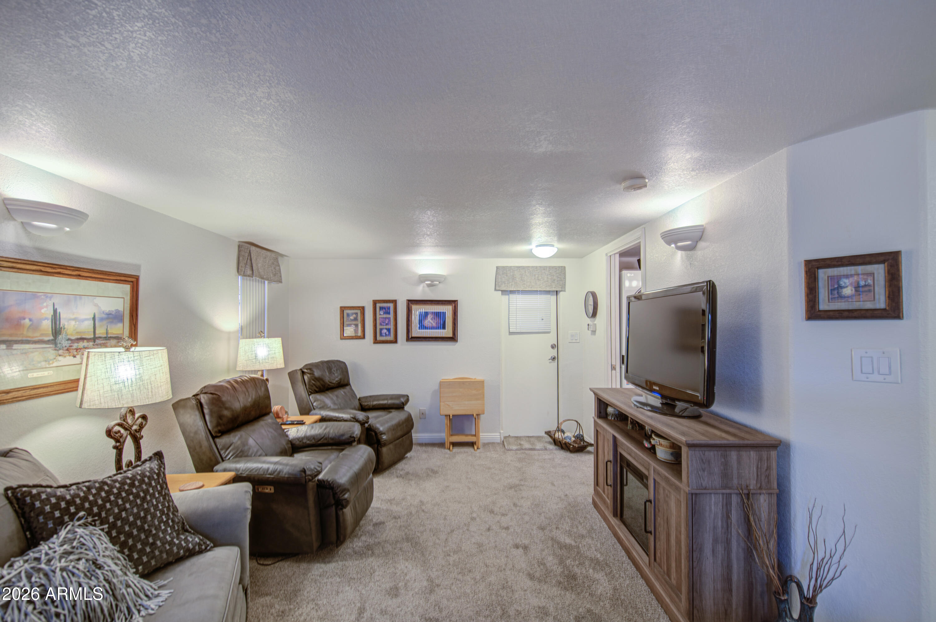 7750 East Broadway Road, Unit 349 Mesa, AZ 85208 - Photo 17 of 39 a living room with furniture and a flat screen tv