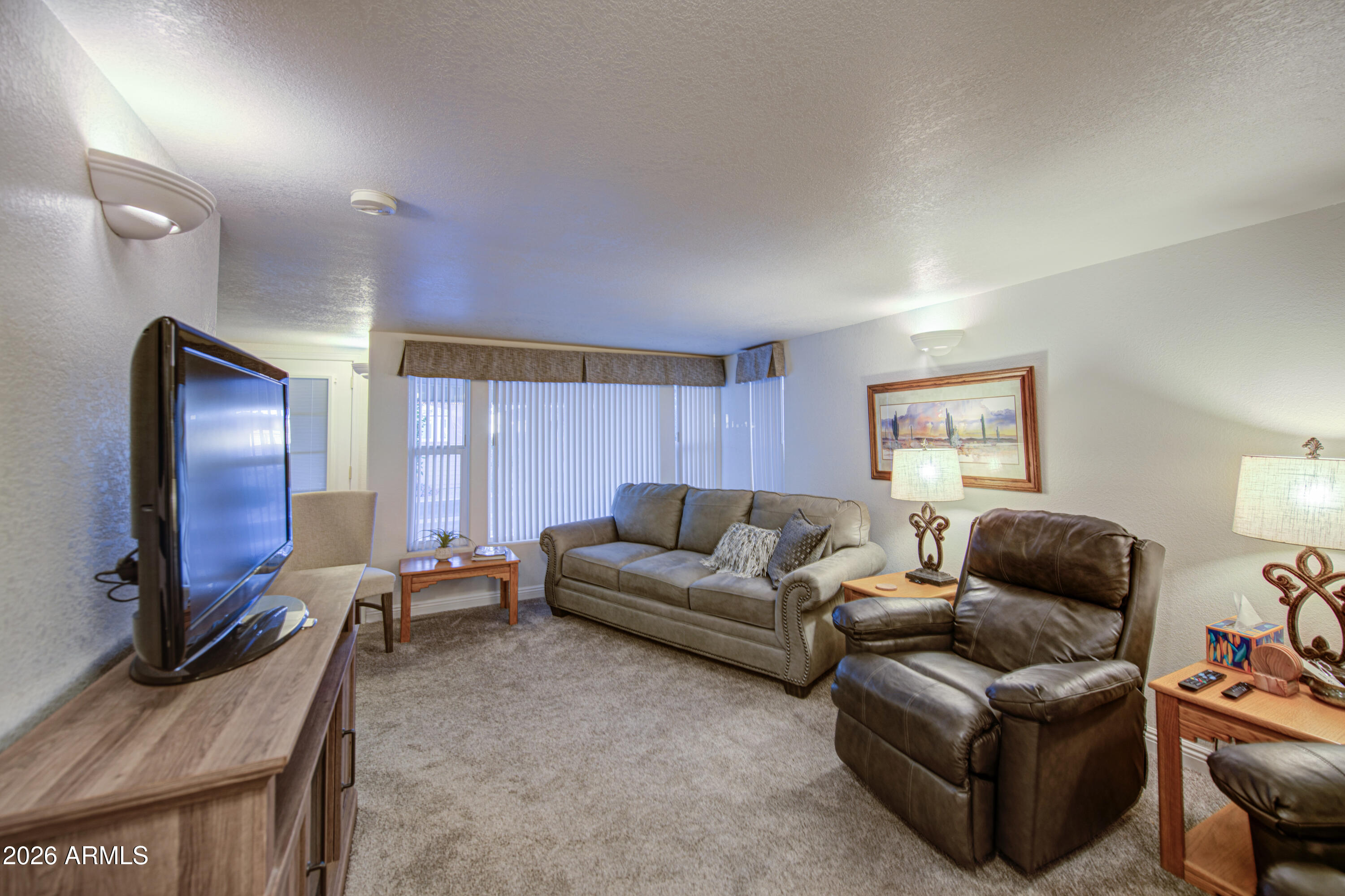 7750 East Broadway Road, Unit 349 Mesa, AZ 85208 - Photo 18 of 39 a living room with furniture window and a flat screen tv