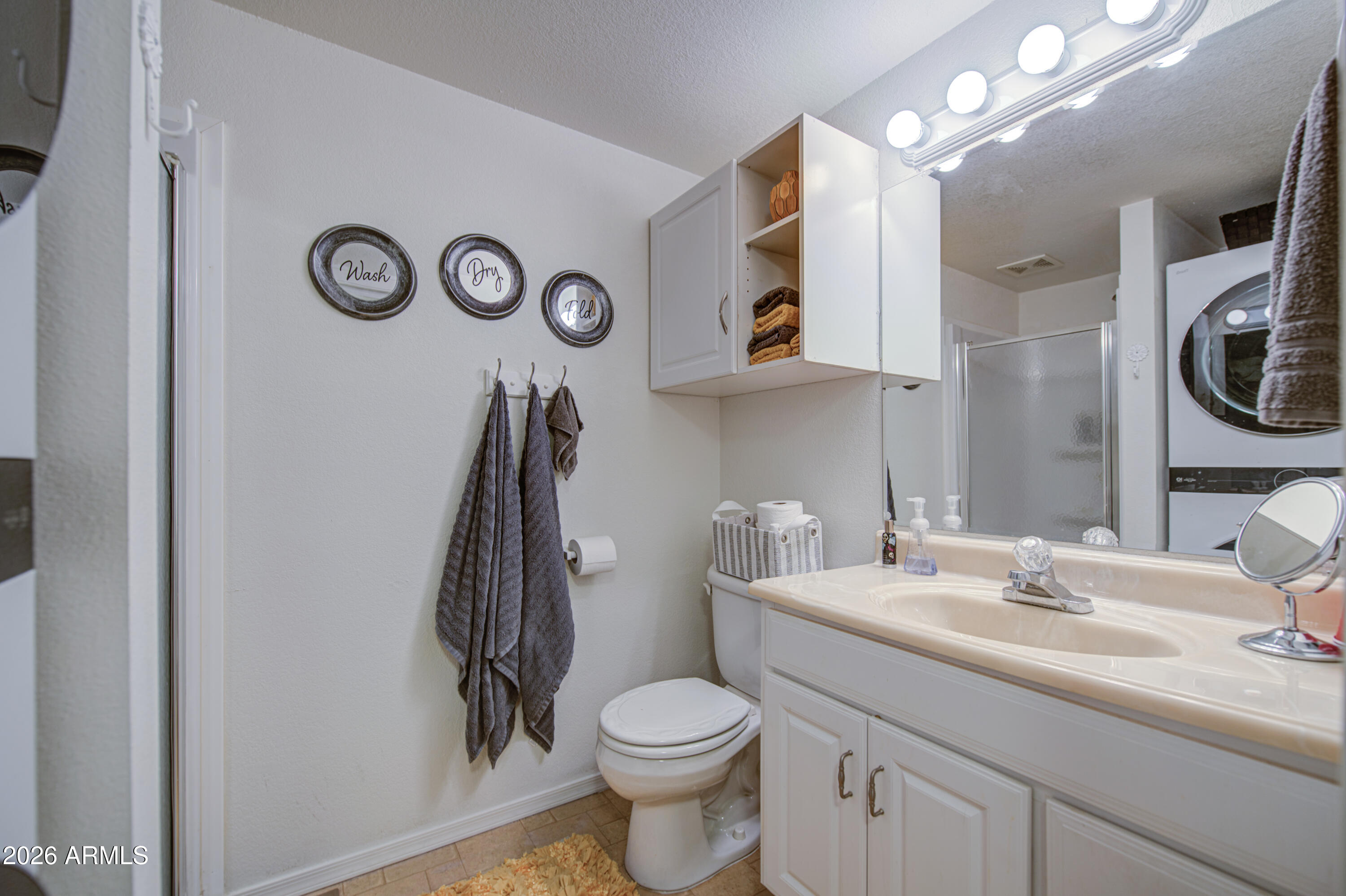 7750 East Broadway Road, Unit 349 Mesa, AZ 85208 - Photo 19 of 39 a bathroom with a toilet sink and mirror