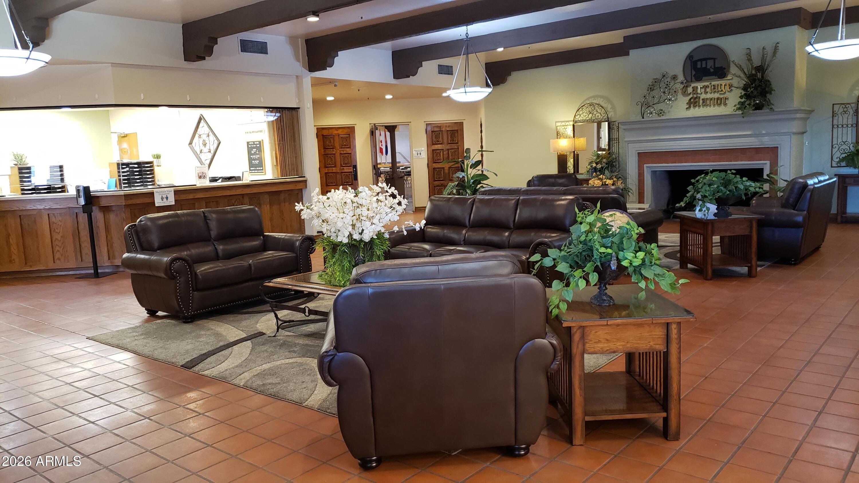 7750 East Broadway Road, Unit 349 Mesa, AZ 85208 - Photo 31 of 39 a living room with furniture flower pot and a fireplace