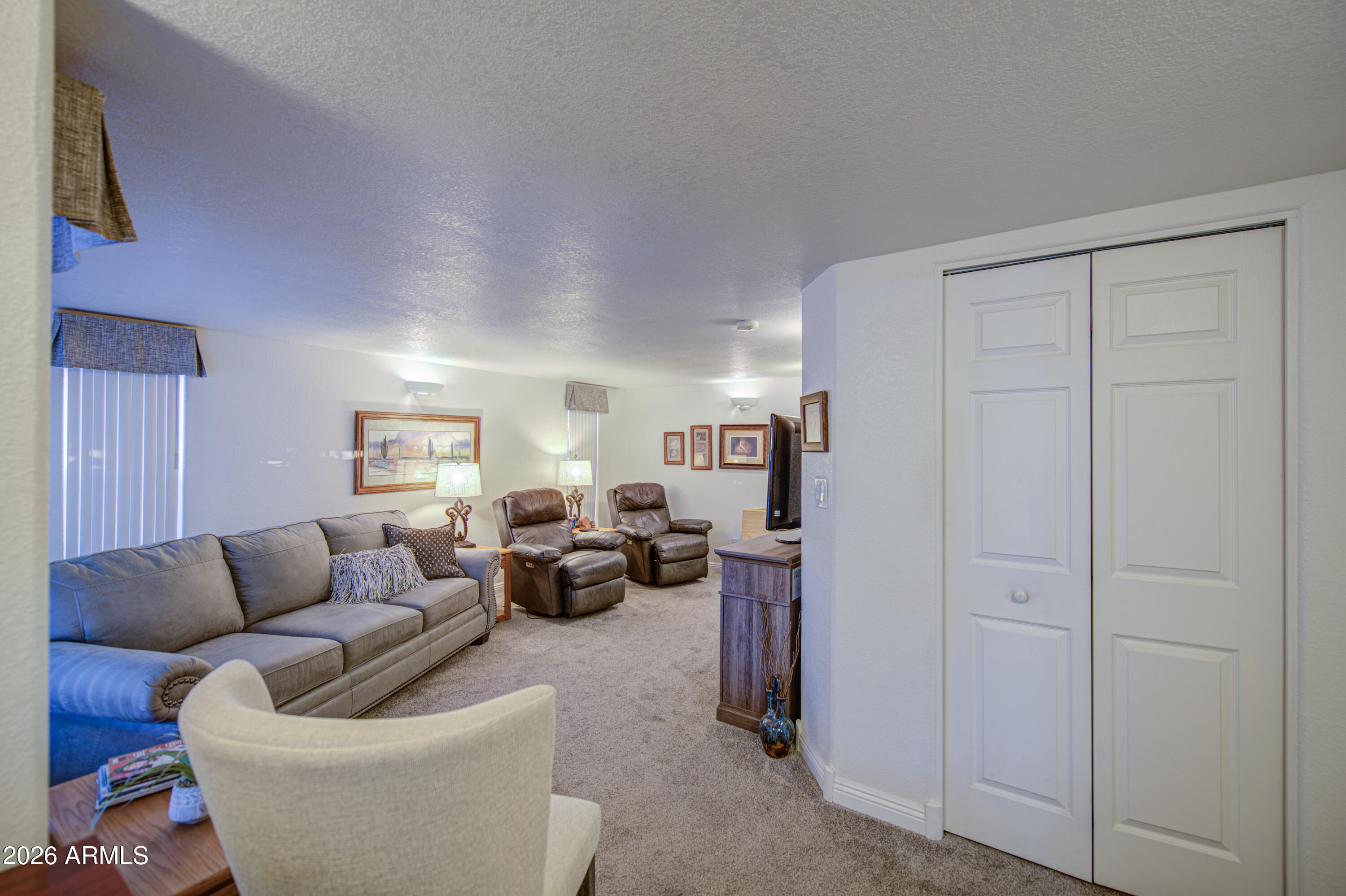 7750 East Broadway Road, Unit 349 Mesa, AZ 85208 - Photo 5 of 39 a living room with furniture and a couch