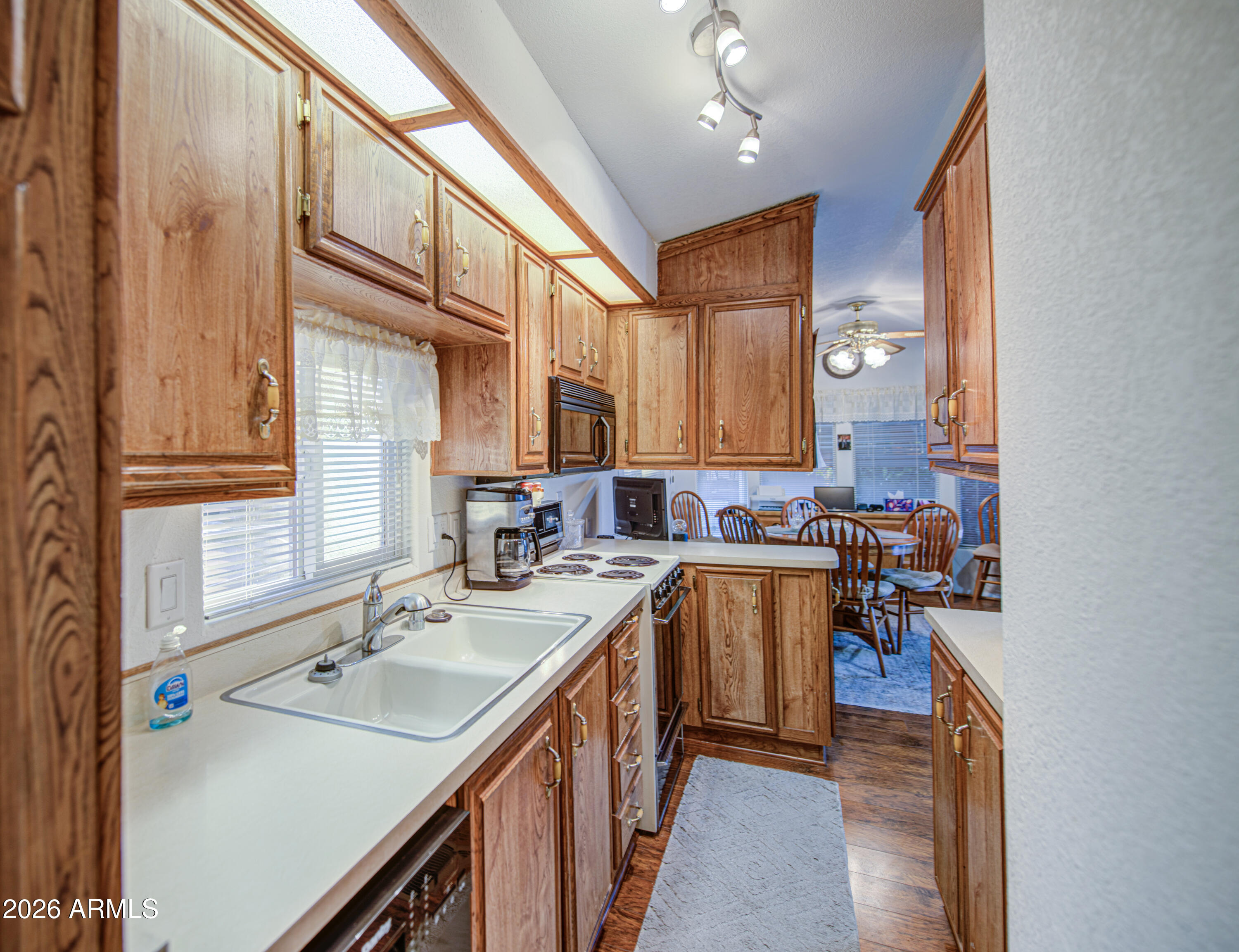 7750 East Broadway Road, Unit 349 Mesa, AZ 85208 - Photo 7 of 39 a kitchen with a sink stove and cabinets