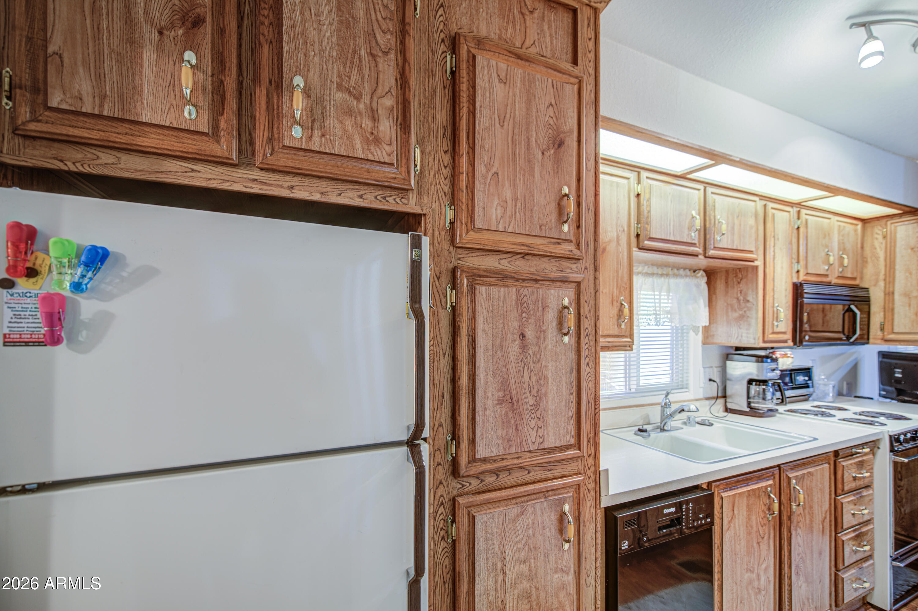 7750 East Broadway Road, Unit 349 Mesa, AZ 85208 - Photo 8 of 39 a kitchen with stainless steel appliances granite countertop a refrigerator and a sink