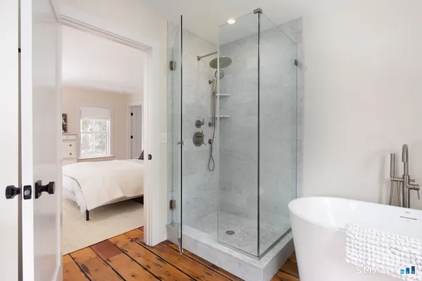 a bathroom with a tub shower and a sink