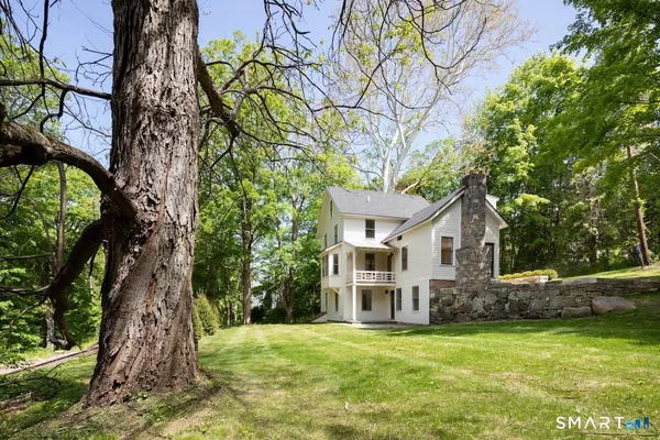 a view of a house with a tree in a yard