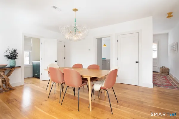 a view of a dining room with furniture and wooden floor
