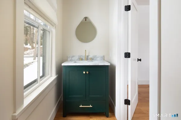 a bathroom with a sink a mirror and a window