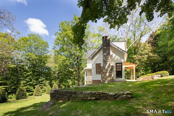 a front view of a house with a garden