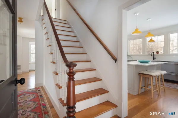 a view of entryway and hall with wooden floor
