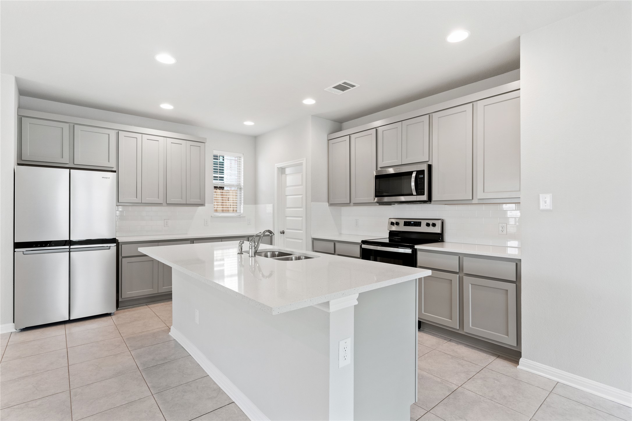 313 Mclintock Road Jarrell, TX 76537 - Photo 9 of 17 A well-appointed kitchen showcasing contemporary cabinetry, bright counters, and recessed lighting.