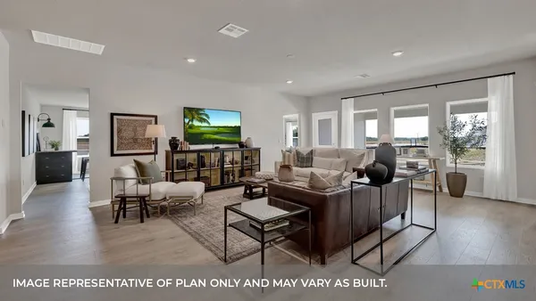a living room with furniture wooden floor and a flat screen tv