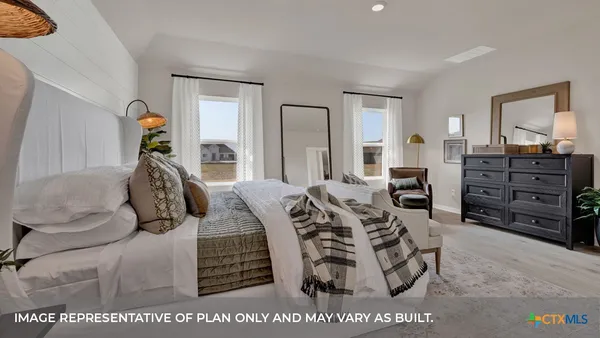a bedroom with a bed a dresser and mirror