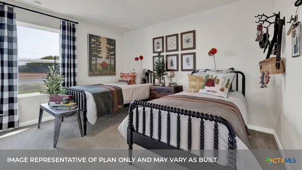 a bedroom with two beds and a potted plant